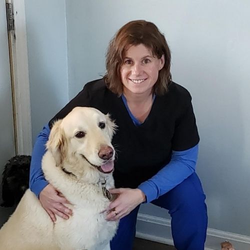 Amy Robinson Kneeling With Her Excited Dog